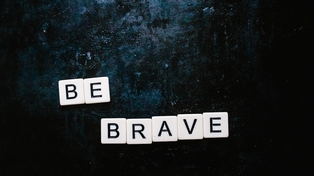 Be brave spelt out using Scrabble letters flatlay